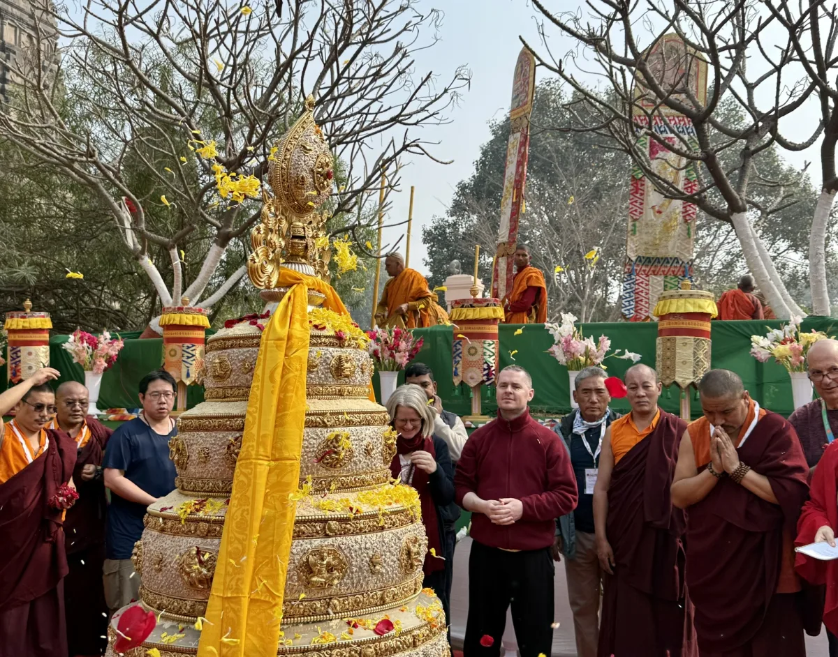 FNT 2026 participants and monastics at a golden offering shrine